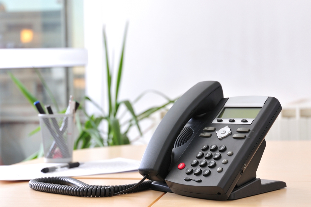 Executive VoIP phone on a beech desk